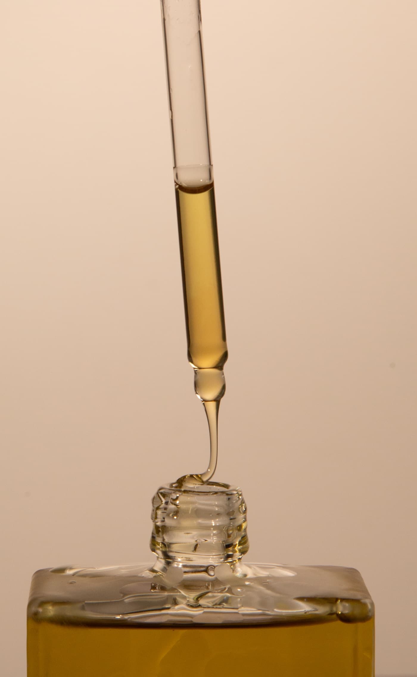 Identity Organics hair oil held in hand